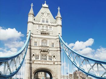 Low angle view of bridge against cloudy sky