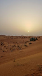 Scenic view of desert against sky during sunset