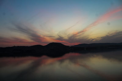 Scenic view of lake against romantic sky at sunset