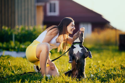 Young woman with dog on field