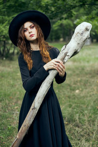 Low angle view of young woman standing on field