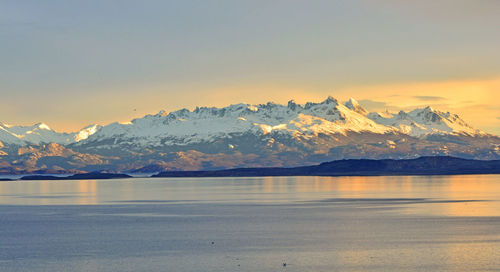 Scenic view of snowcapped mountains against sky during sunset