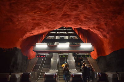 People standing on escalator in subway station