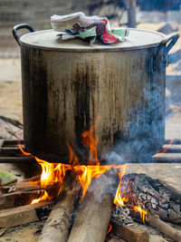 Steel pot on an open fire with firewood