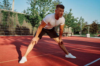 Full length of man exercising on road