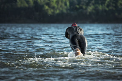 Woman in wetsuit in sea, sweden