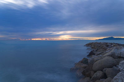 Scenic view of sea against sky at sunset