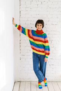 Portrait of woman standing against wall