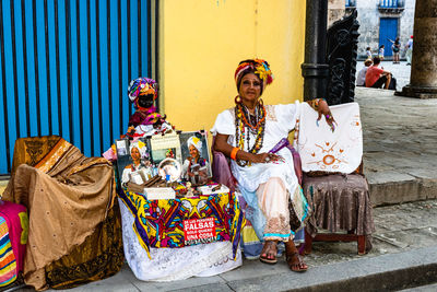 Portrait of couple sitting on street