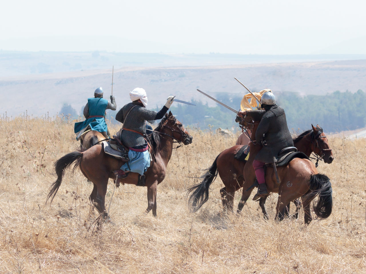 MEN RIDING HORSE ON FIELD