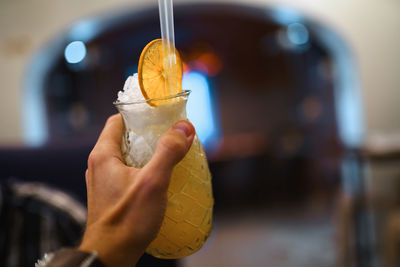 Close-up of hand holding drink