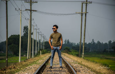 Full length of man standing on railroad track