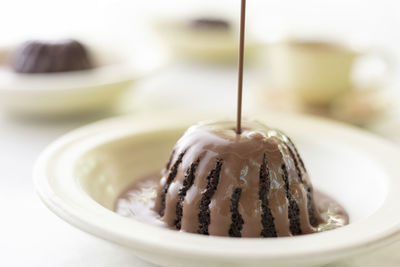 Hot chocolate poured in chocolate cake