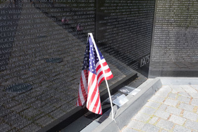 High angle view american flag by wall at war memorial
