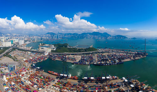 High angle view of buildings by sea against sky