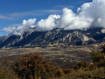 Scenic view of mountains against cloudy sky