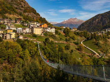 High angle view of townscape by mountain against sky