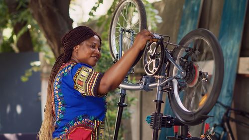 Portrait of young woman with bicycle