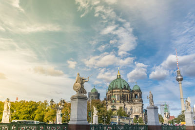 Statue of building against cloudy sky