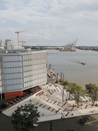 High angle view of city by buildings against sky