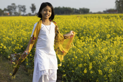 Young woman standing in field