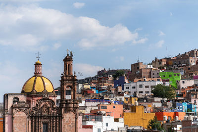 Panoramic view of buildings in city against sky