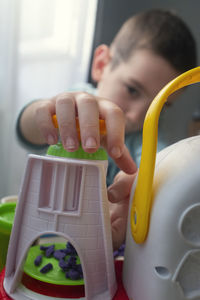 Portrait of boy playing with toy