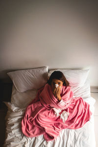 Portrait of woman relaxing on bed at home