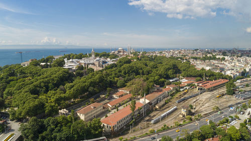 High angle view of trees and buildings against sky