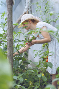 View of young woman gardening