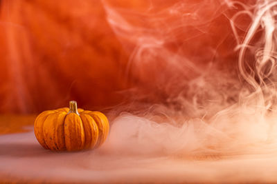 Close-up of pumpkin against orange background