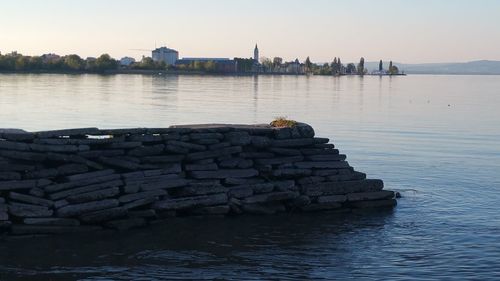 Stack of rocks in river against sky