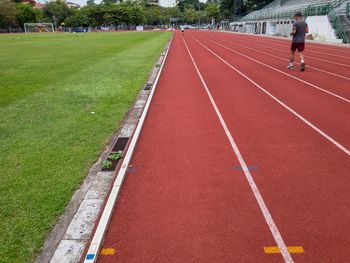 Rear view of man running on tracks