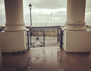 Walkway in city against sky