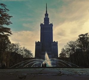 Fountain against building in city