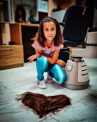 Portrait of girl sitting on floor at home