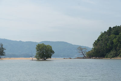 Scenic view of sea and mountains against sky