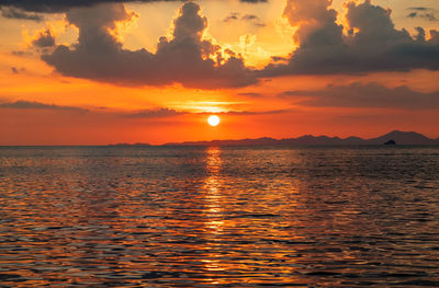 Scenic view of sea against romantic sky at sunset