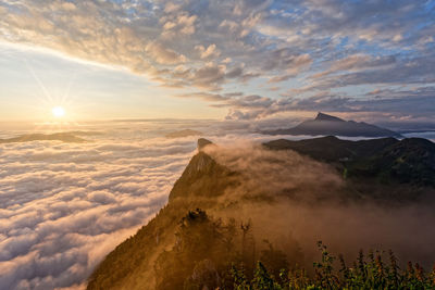 Scenic view of snowcapped mountains against sky during sunset