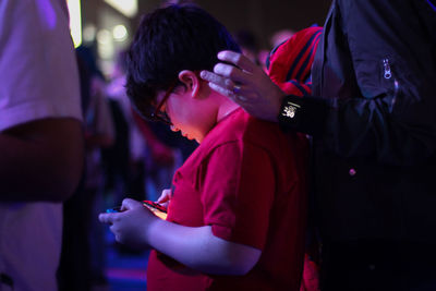 Side view of a boy holding hands