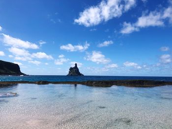 Scenic view of sea against blue sky