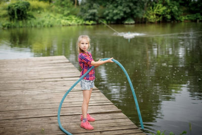 Full length portrait of woman standing on pink lake