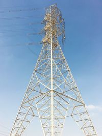 Low angle view of water tower against clear blue sky