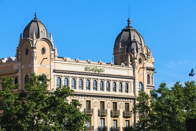 Low angle view of historic building against clear blue sky