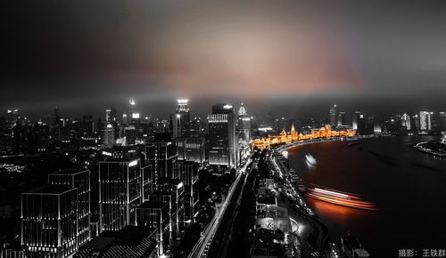 High angle view of illuminated city buildings at night