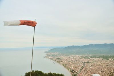 Wind sock overlooking sea against sky