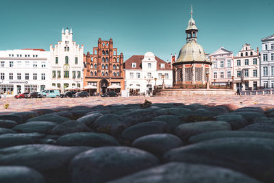 View of buildings in town against clear sky