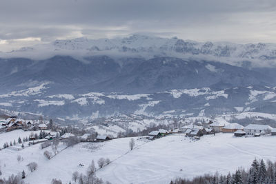 Scenic view of snow covered mountains against sky