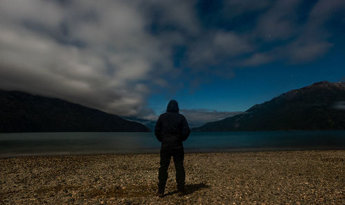 Rear view of man standing on beach