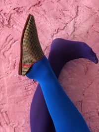 Low section of person wearing pink shoes outdoors